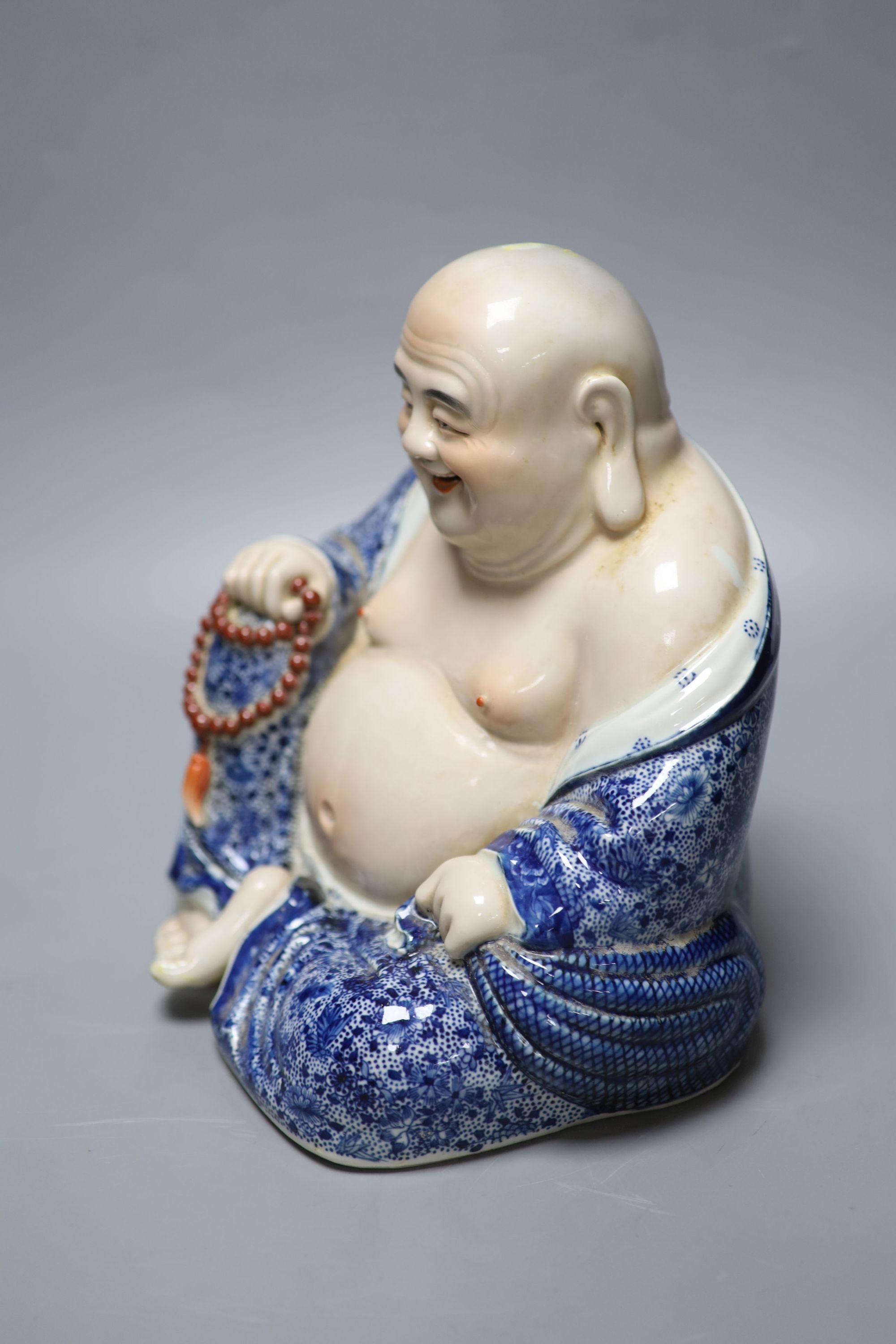 A Chinese porcelain figure of Budai, height 26cm